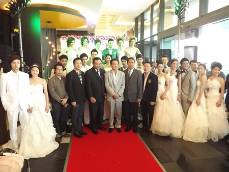 Honored guests pose with the models after the wedding dress fashion show at the Tsix5 Hotel.